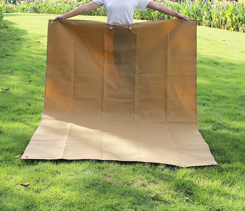 Beige waterproof picnic mat spread flat with corner grommets.