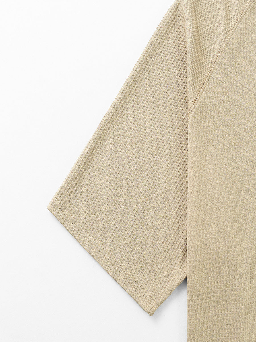 Men's waffle knit tee sleeve and side seam in khaki, textured waffle knit fabric