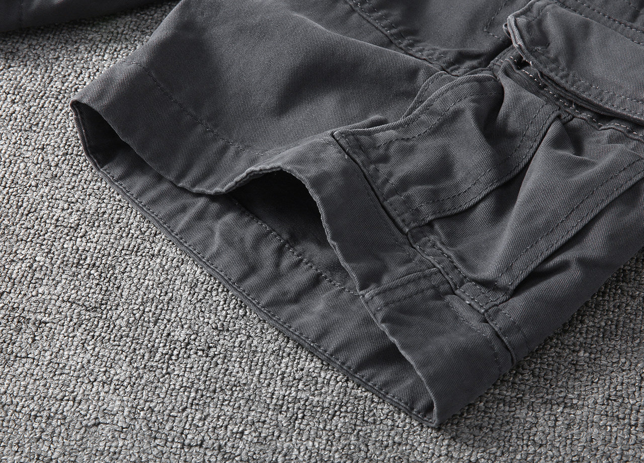 Hem and stitched leg opening of dark gray cargo shorts with side seam detailing