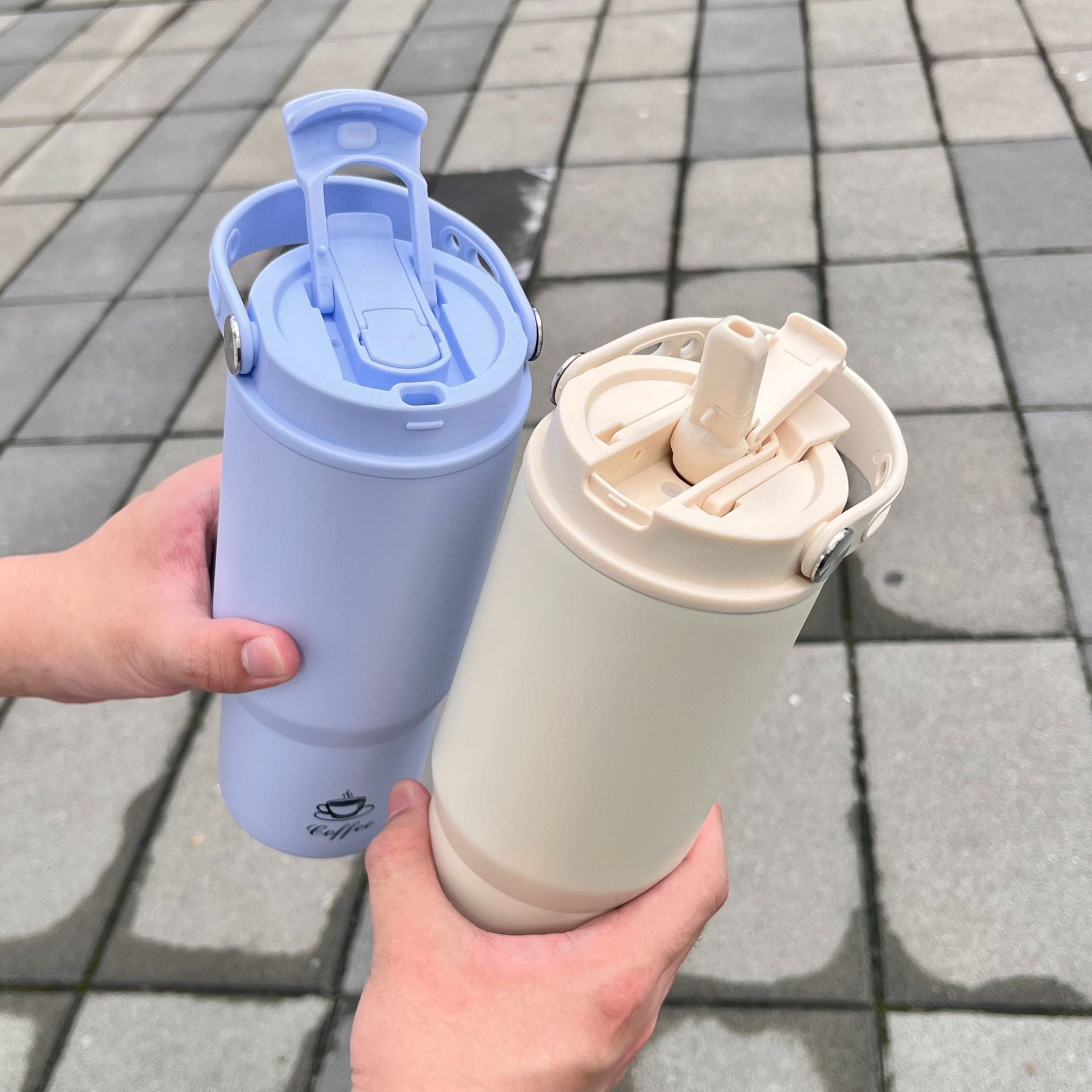 Portable stainless steel insulated bottle set with open lids, blue and cream