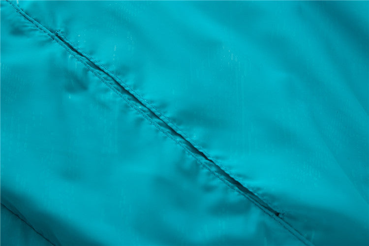 Hooded sun protection jacket, turquoise blue diagonal seam detail