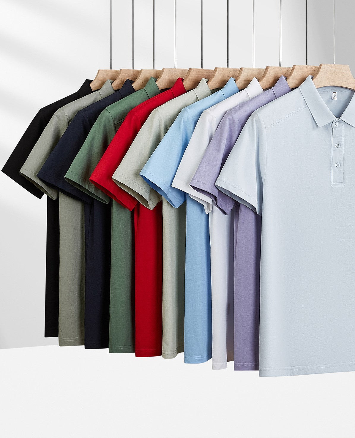 Men's polo shirts rack display: multiple colors, short sleeves, button plackets, folded collars.
