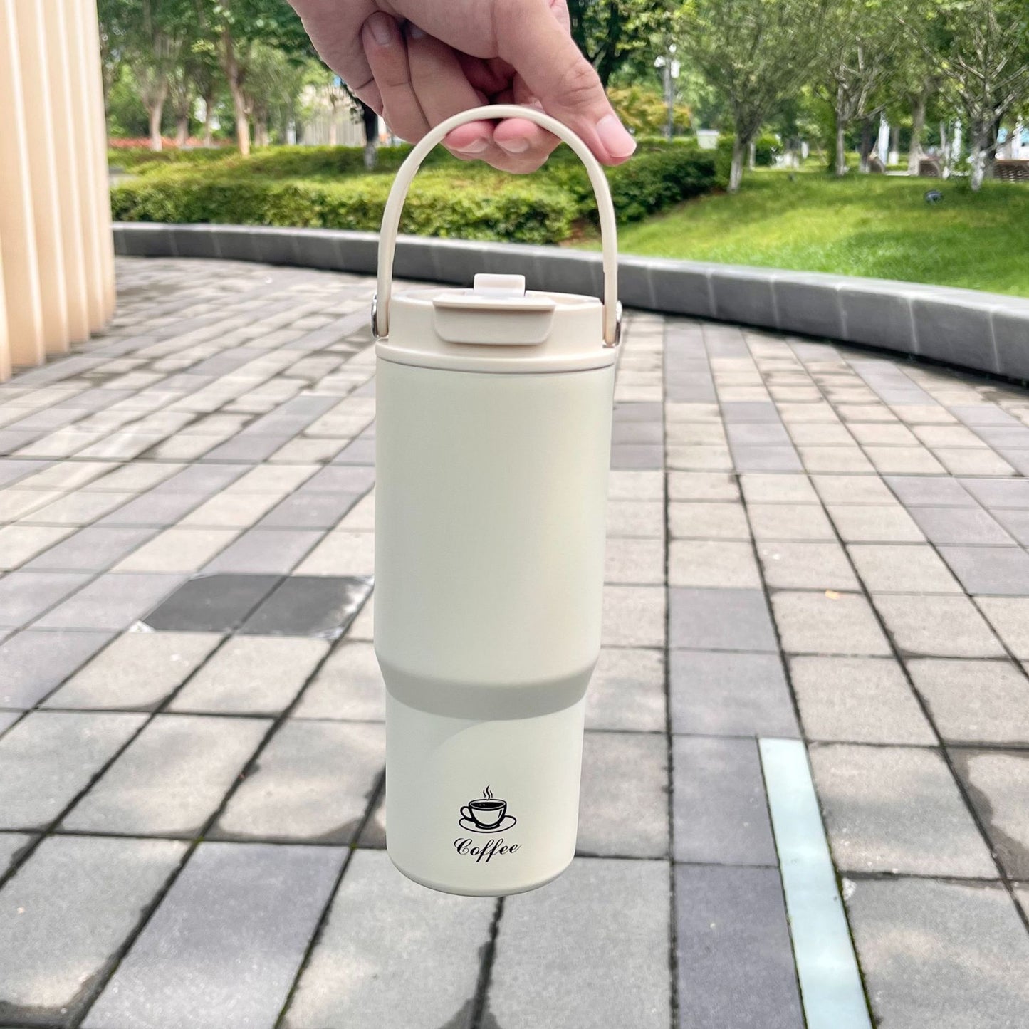 Portable stainless steel insulated bottle, white, with carry handle and flip lid