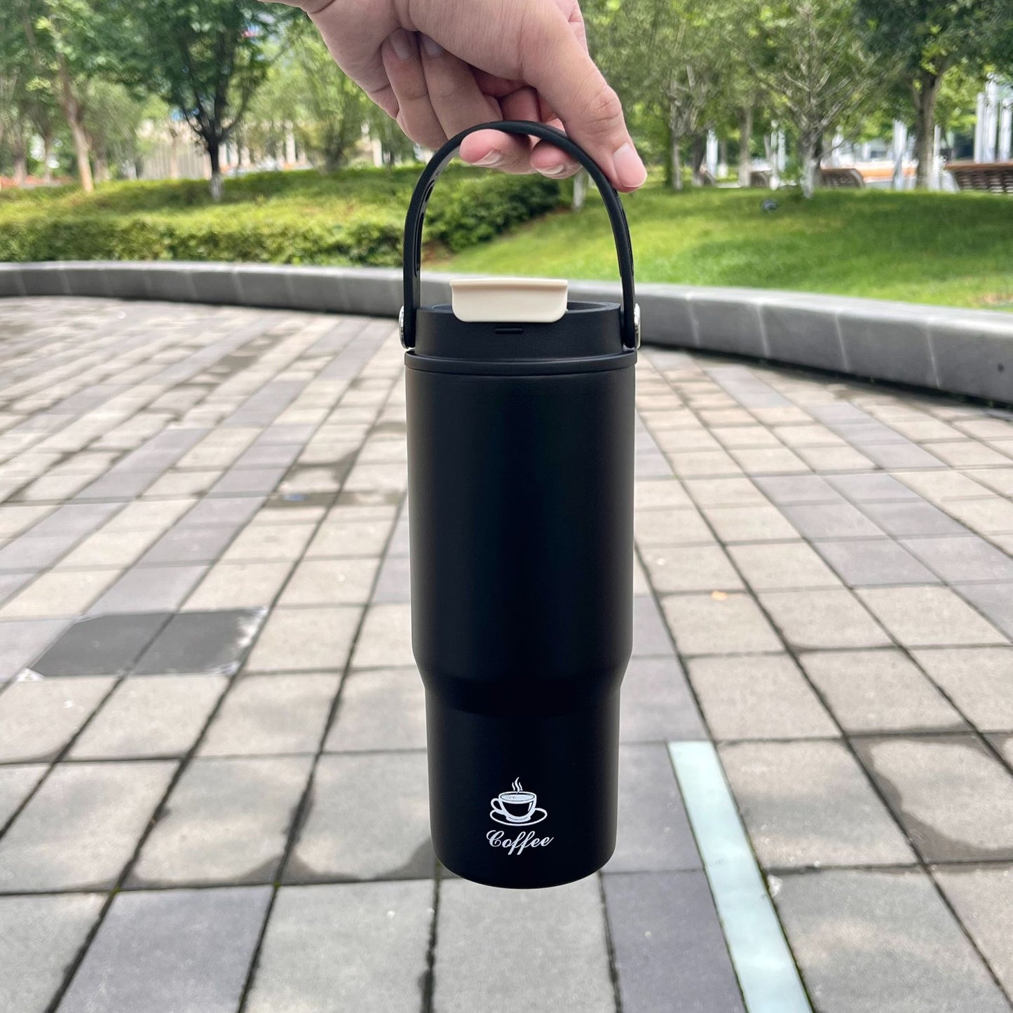 Portable stainless steel insulated bottle, black, with carry handle and flip lid