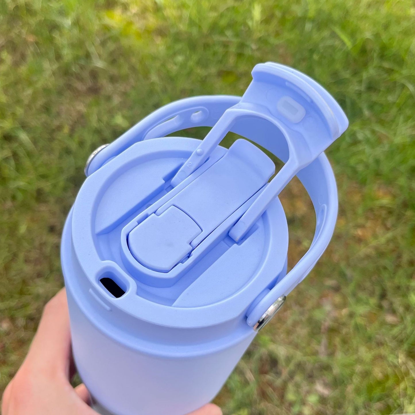 Light blue portable insulated bottle lid mechanism with flip-up carry handle