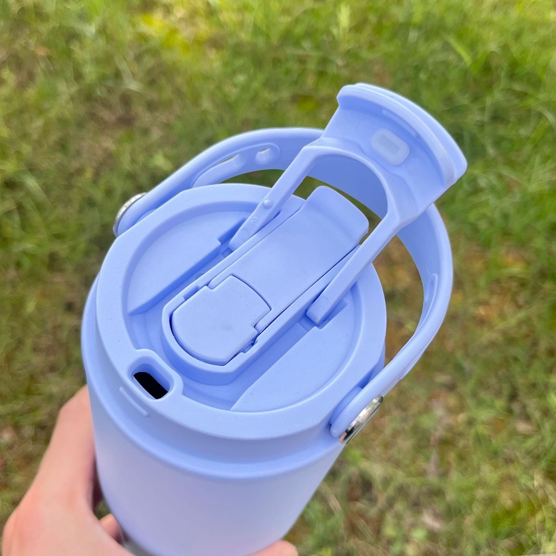 Light blue portable insulated bottle lid mechanism with flip-up carry handle