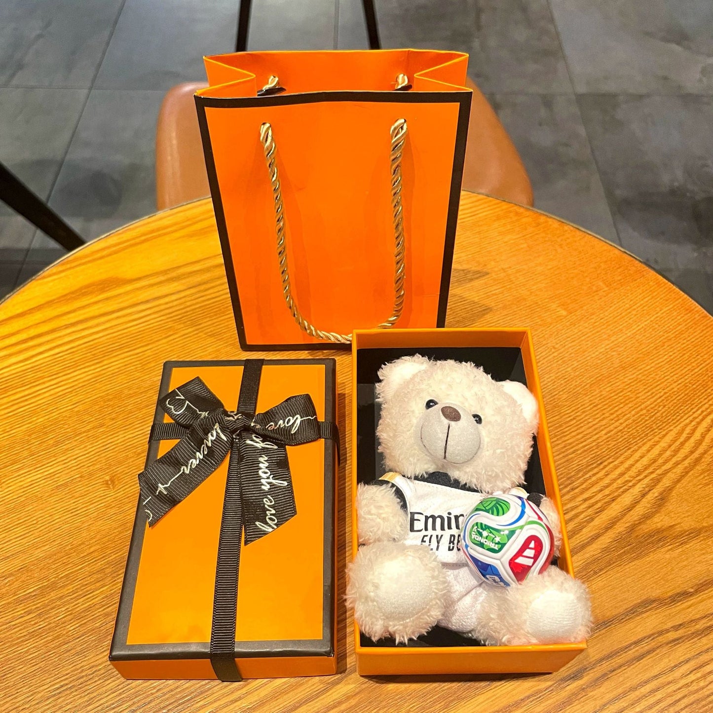 Gift box set with white plush bear keychain in white jersey holding a red-white-blue soccer ball