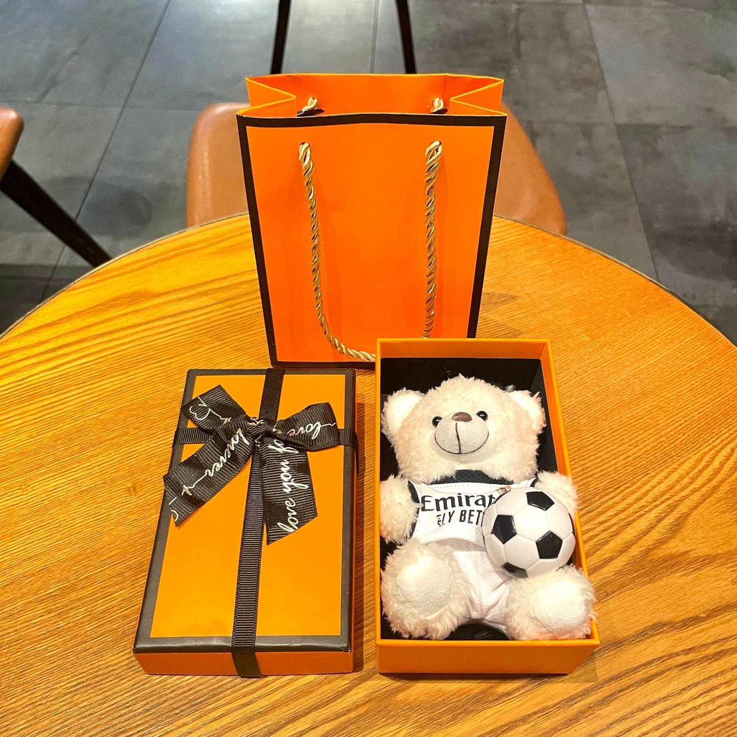 Gift box set with white plush bear keychain in white Emirates jersey holding a soccer ball