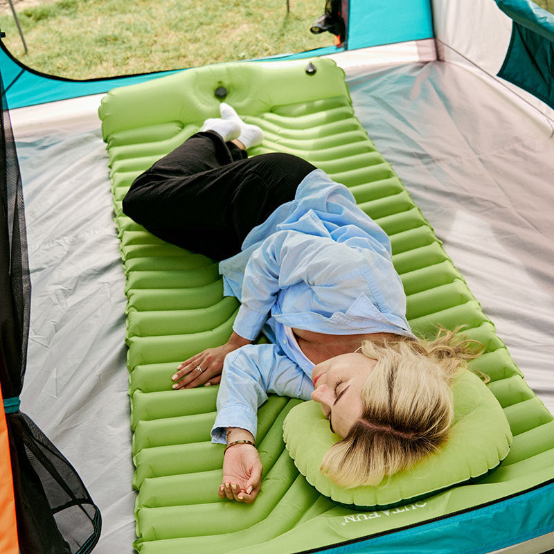 Emerald green inflatable camping sleeping pad with raised pillow, horizontal ribbing