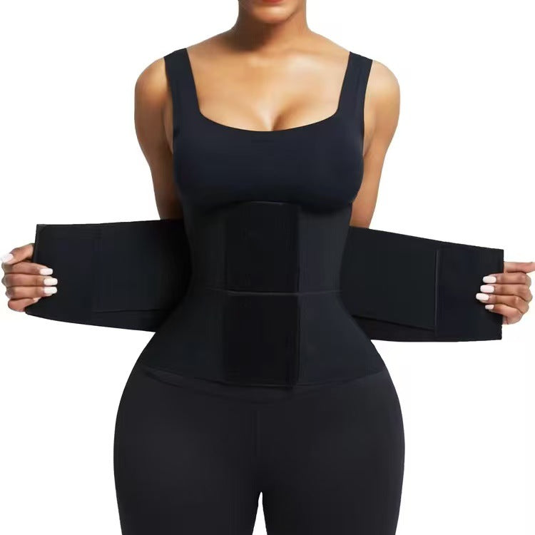 Black waist trainer belt laid flat with wide adjustable wrap panels