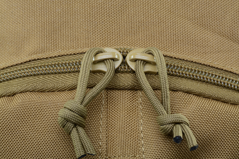 Tan backpack close-up with drawstring cord and textured fabric front panel