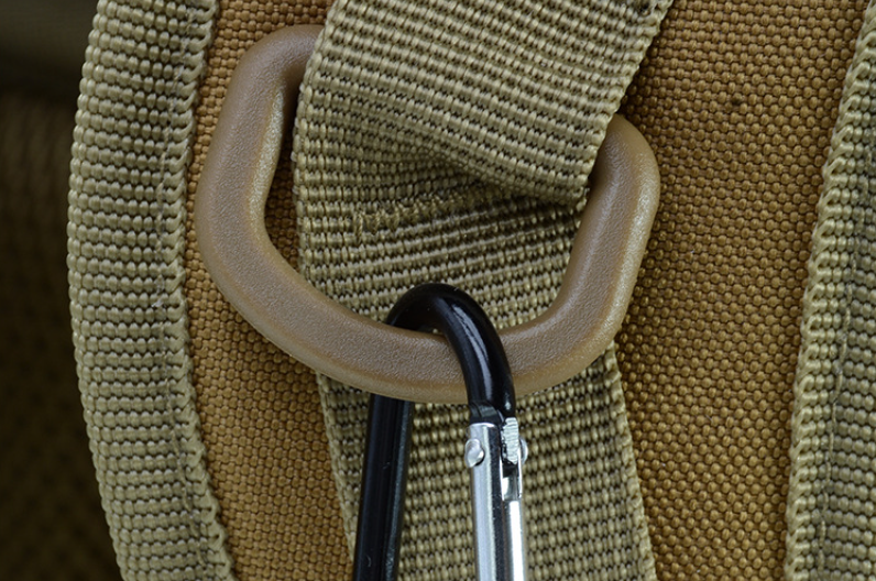Tan backpack close-up with webbing strap and metal D-ring