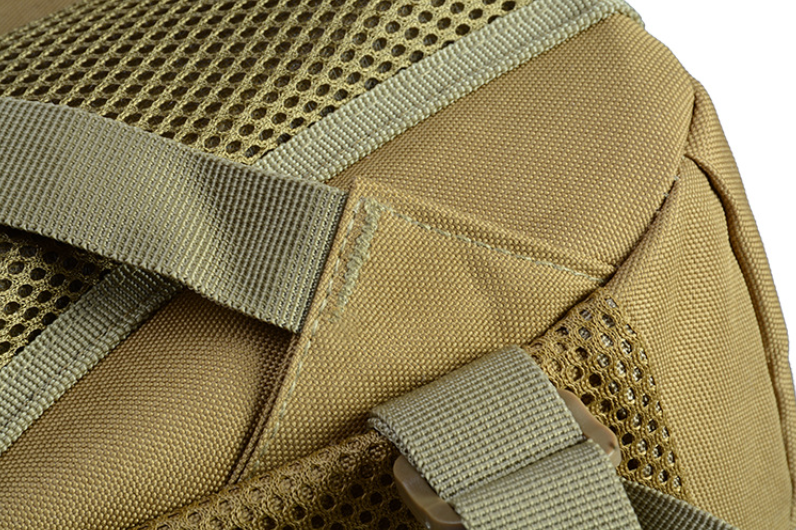 Tan backpack close-up of mesh panel and webbing reinforcements near pocket