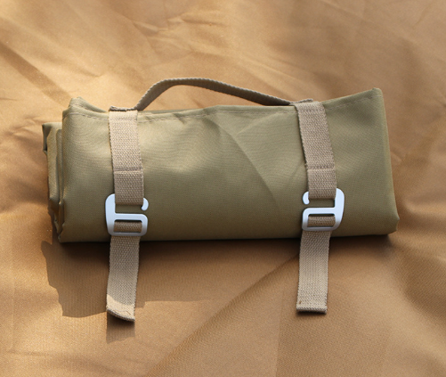 Khaki waterproof mat carry bag close-up with front buckled webbing straps.