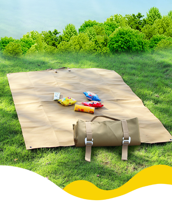 Khaki waterproof picnic mat folded with attached carry straps and buckles