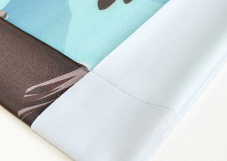 Light blue seamless stretch face mask fabric with visible stitched edge