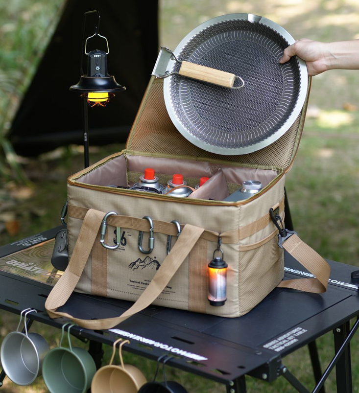 Khaki tactical camping storage bag open with front organizer pocket and webbing handles.