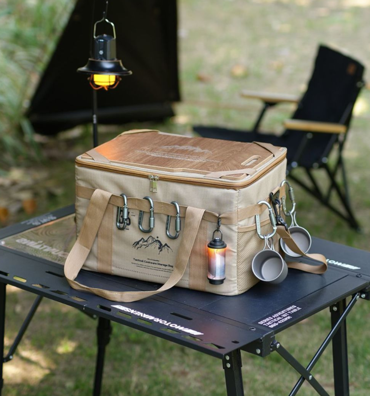 Khaki tactical storage bag on outdoor table with side organizer pockets