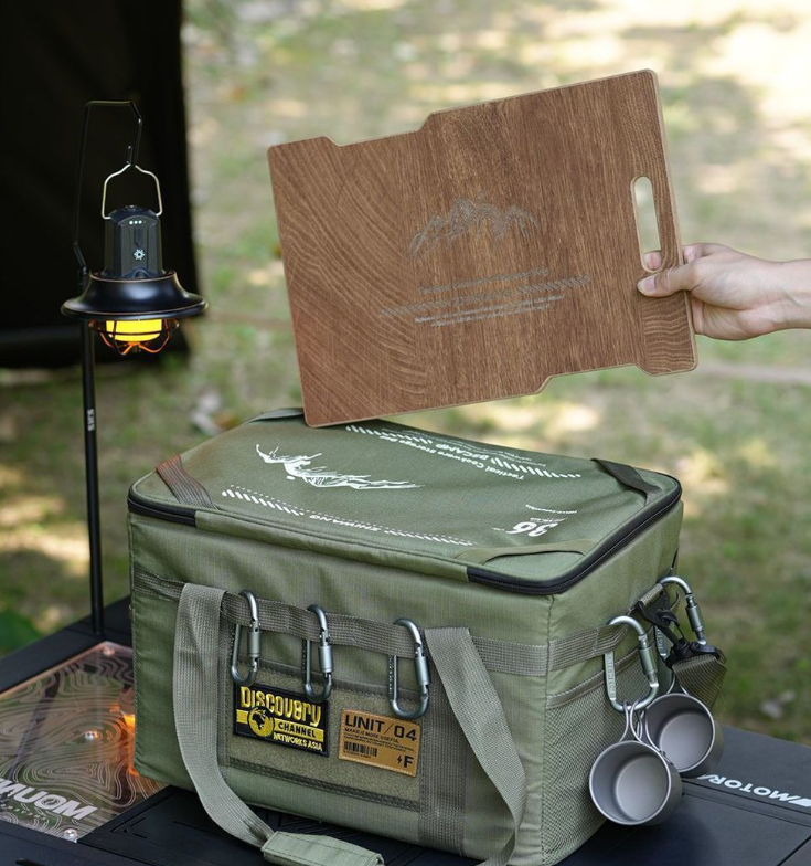 Green tactical storage bag with wooden tabletop and carry handles with carabiners