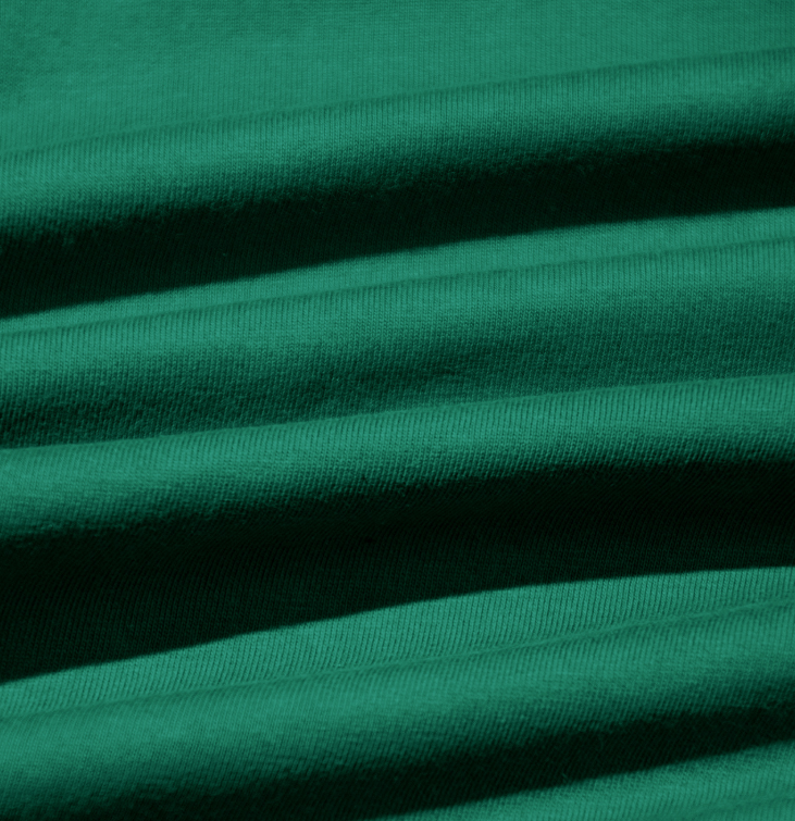 Green knit fabric close-up for a crew neck basic tee