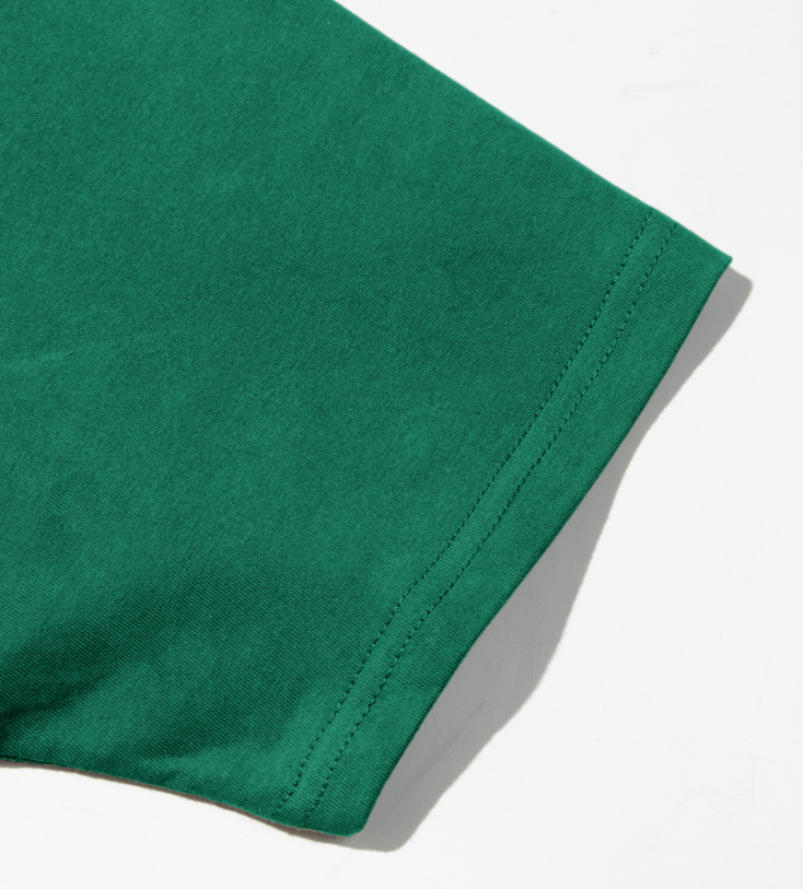 Men's green crew neck tee sleeve cuff with double-stitched hem